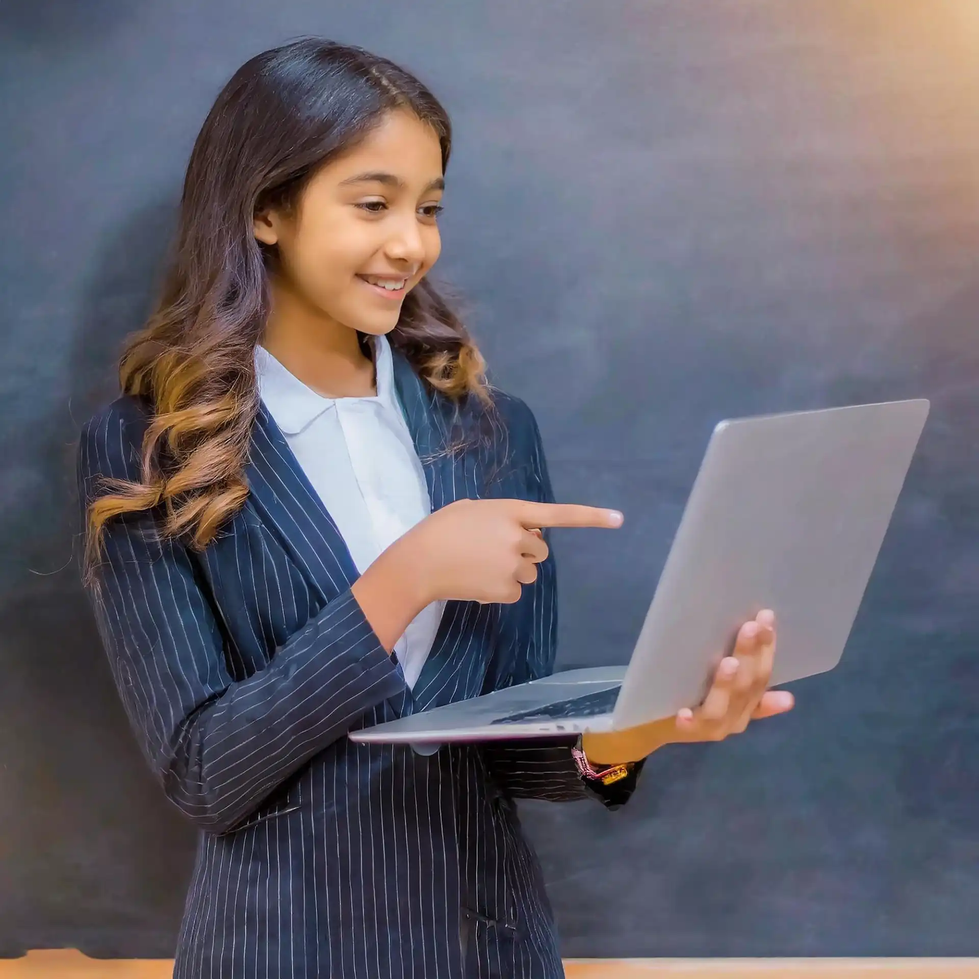 Beautiful girl using laptop pointing background black